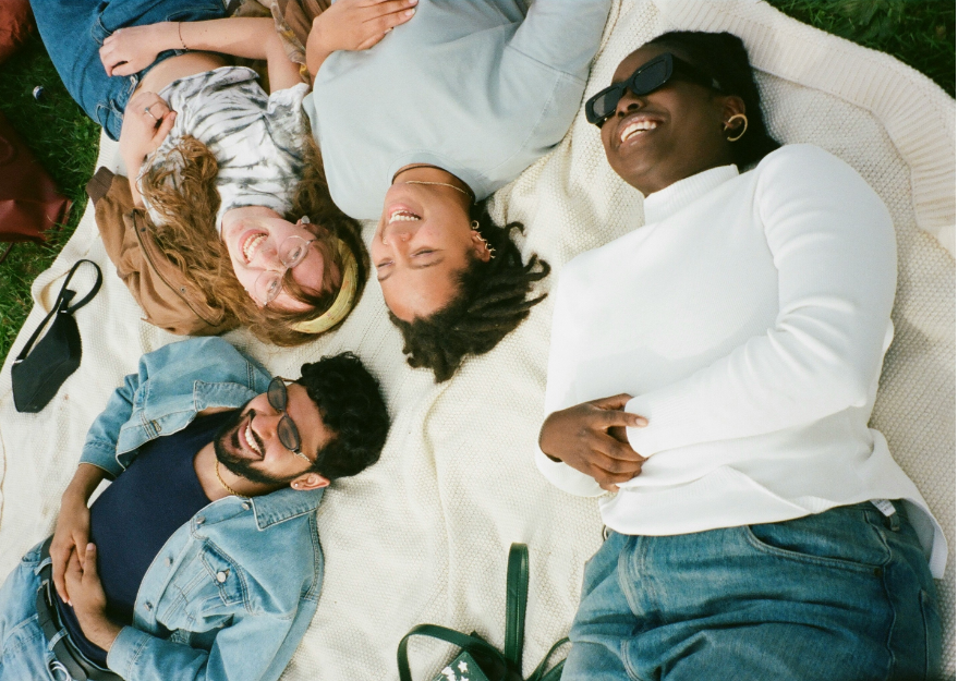 Happy people laying outside on a blanket